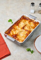 Step by step cooking of lasagna with mushrooms and chicken on a light concrete background. Step by step recipes.