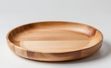 A smooth, organic-shaped wooden bowl rests on a clean white background.