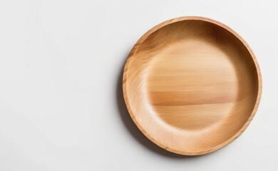 A smooth, organic-shaped wooden bowl rests on a clean white background.