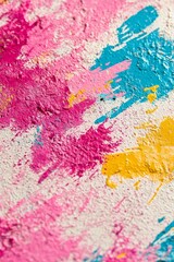 Abstract Texture Vibrant Splashes Of Blue, Pink, And Yellow Paint On Textured, White Wall.