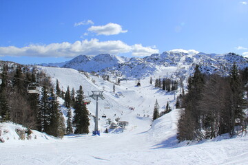 People having ski time in ski resort on a cold winter sunny day.