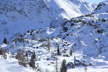 People having ski time in ski resort on a cold winter sunny day.