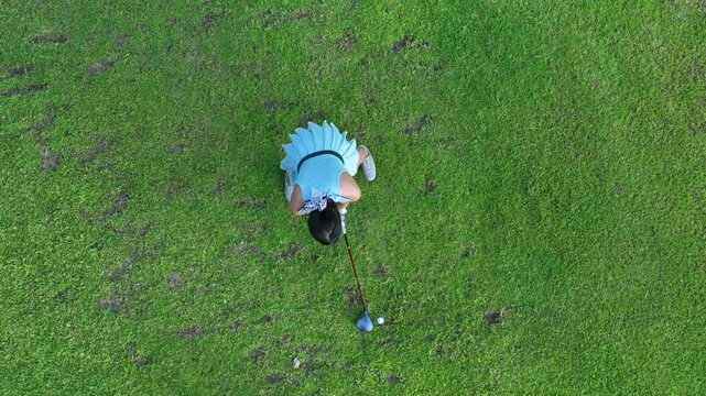 Aerial view asian girl play golf on green golf course, Woman golf player swing golf club practice, Asian girl golf player, People lifestyle