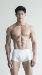 Fototapeta premium The handsome Asian male in white swimming pant