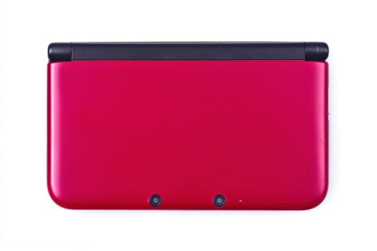 Neu-Ulm, Bavaria, Germany - January, 23, 2025: Nintendo 3DS XL handheld game console seen directly above. Isolated on white background.