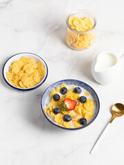 cornflakes  in a bowl on a light background, breakfast