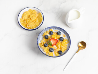 cornflakes  in a bowl on a light background, breakfast