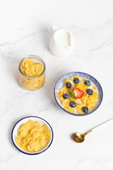 cornflakes  in a bowl on a light background, breakfast