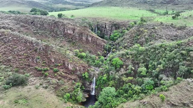 Drone view of a waterfall amidst cerrado vegetation in Serra da Canastra