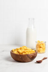 cornflakes  in a bowl on a light background, breakfast