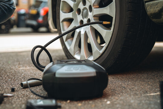 Tire inflation process using compressor on a vehicle in a parking area