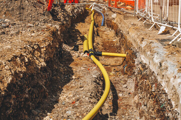 Construction site with trench for gas main pipe and utility installation 