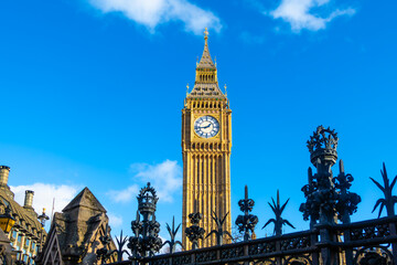 Iconic clock tower in London, known as Big Ben, against a clear blue sky 
