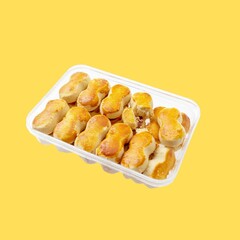 Peanut-Shaped Cookies in Transparent Container Against a Yellow Background
