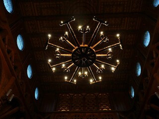 Ornate chandelier in a dimly lit interior.