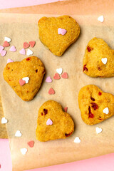 Heart shaped cookies with sweet confetti,sprinkles, pastry bakery food.pink background for Valentines day, womens day, love, romance, party pattern.
