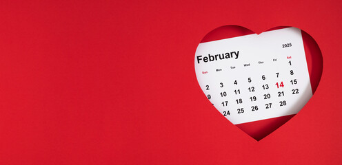 Top view of a red heart frame with a calendar sheet for February 14, 2025, marked in red, placed inside. Valentine's Day calendar. Flat lay.