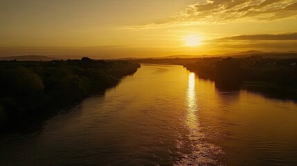 Golden sunset over river, calm landscape, aerial view, peaceful evening
