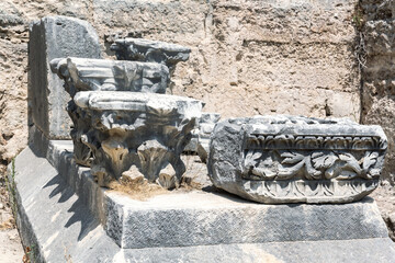 Close-up of intricately carved stone capitals and fragments of ancient architecture. Perge archaeological site, Turkey (Turkiye)