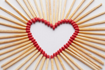 Close-up of heart made of match sticks on white background - Love concept