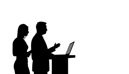 Silhouettes of two people presenting at a podium with laptop