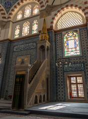 Fototapeta premium Interior of a Mosque, featuring an ornate minbar, intricate tiles, and stunning stained glass windows. A masterpiece of Ottoman architecture and Islamic art.