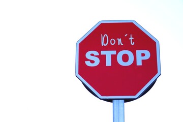 don't stop. lifestyle. words written on a stop sign.