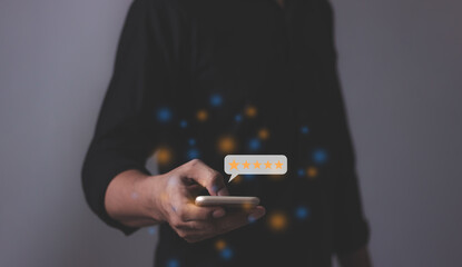 Review Customer, Young Man hand holding Smart Phone with five star to review and give 5 stars with very good results in service, Good review 5 star rating choice feedback