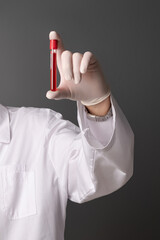 Scientist/Medical Professional in white gloves holding a Test Tube,.Blood Sample in Laboratory...