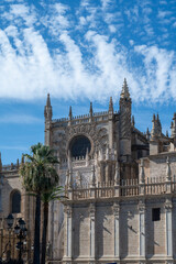 Fototapeta premium Walking in old historical Andalusian town Seville, Cathedral church, Spain. View on houses, streets, architectural details of buidings. Summer in Andalusia.