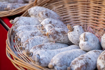 Variety of homemade dried salami sausages in French butchery shop, Dordogne, France, meat food background close up