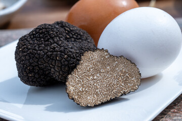 Ingredients for French omelette with mushrooms, fresh farmers eggs and black summer truffle...