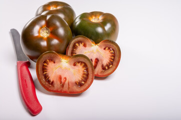 Fresh ripe sweet reddish brown and green kumato tomatoes close up