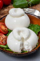 Cheese collection, eating of fresh soft white burrata cheese ball made from mozzarella and cream from Apulia, Italy, close up