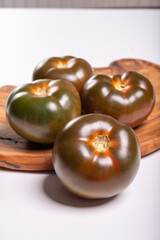 Fresh ripe sweet reddish brown and green kumato tomatoes close up