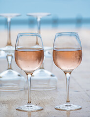 Summer time in Provence, two glasses of cold rose wine with blue sea view on background, French Riviera near Menton, south of France