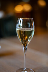 Tasting sparkling white wine, traditional champagne method making of cremant in caves on Moselle river valley in Luxembourg, glass of wine