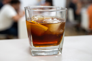 Tasting Sherry sweat cream wine on ice rocks, jerez fortified wine made from palomino white grape served in Jerez de la Frontera, Cadiz, Andalusia, Spain