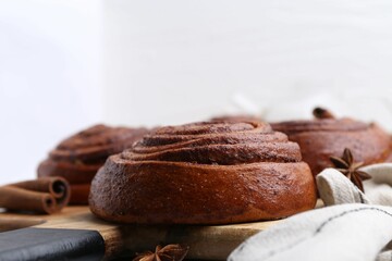 Delicious cinnamon roll buns on table, closeup