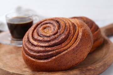 Delicious cinnamon roll on white table, closeup