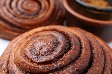 Tasty cinnamon roll buns as background, closeup