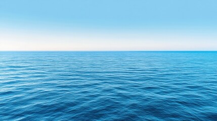 Obraz premium A peaceful view from an airplane window of a vast blue ocean, with small white waves 