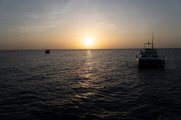 Boats and Sun Dipping Below the Horizon in Zanzibar