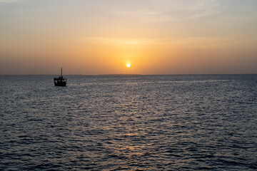 Boats and Sun Dipping Below the Horizon in Zanzibar