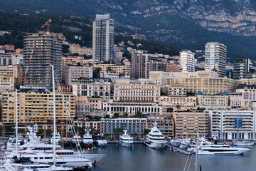 A close-up view of Monaco's luxurious harbor, showcasing grand buildings, sleek yachts, and modern...