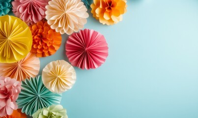 Obraz premium Colorful paper decorations arranged on a light blue background