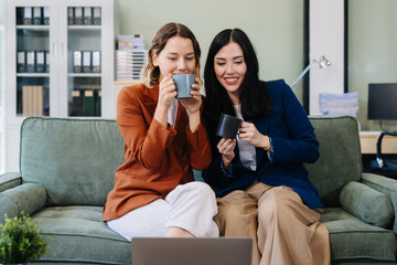 Female colleague caucasian descent holds a cup of coffee and talking discussion ideas and happily.