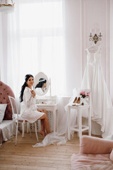 black-haired bride girl getting ready in boudoir