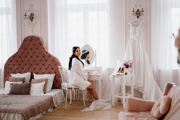 black-haired bride girl getting ready in boudoir