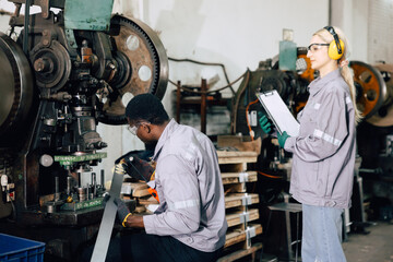 black worker working in heavy industry factory with women supervisor training young new worker